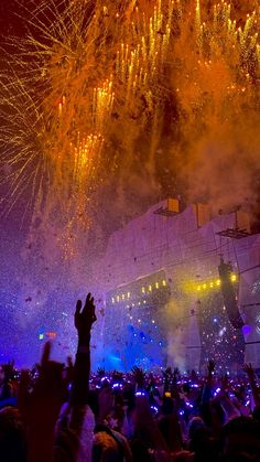 fireworks are lit up in the night sky at a concert