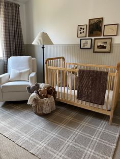 a baby's room with a crib, chair and teddy bear in it