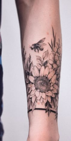 a woman's arm with flowers and a bird on it