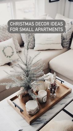 a living room with a couch, coffee table and decorative items on top of it