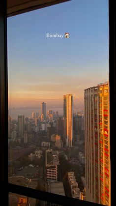 the city skyline is seen through an open window at sunset in this view from a high rise building