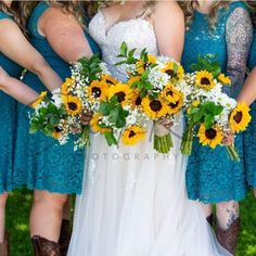 the bride and her bridesmaids are holding sunflowers in their bouquets