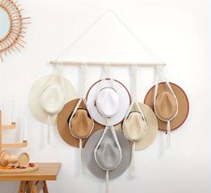 hats are hanging on the wall with hooks