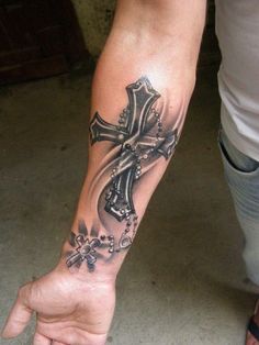 a person with a cross tattoo on their arm