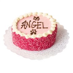 a pink and white cake with the word angel written on it's frosting