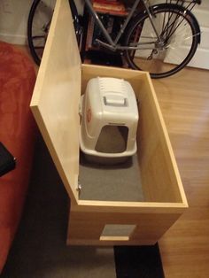 an open drawer on the floor next to a bike