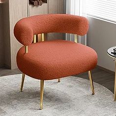 an orange chair sitting on top of a white rug