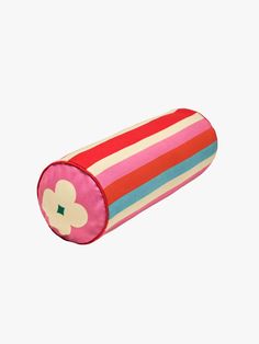 a pink and red striped cylinder with a flower on it