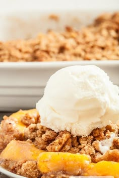 a close up of a plate of food with ice cream on top and bananas in the background