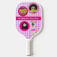 a pink and white racket with pictures of dogs on the front, along with an image of a man's face