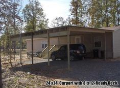 a car is parked in front of a two story house with a carport attached to it