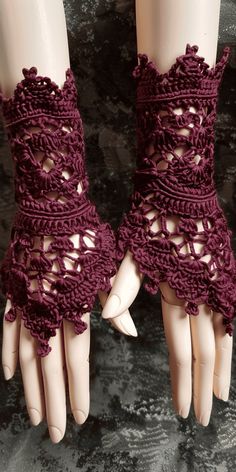 a pair of gloves with crocheted laces on them