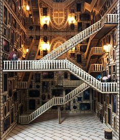 a staircase in the middle of a building made out of bookshelves and stairs