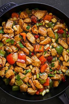 chicken stir fry in a skillet with peppers and corn