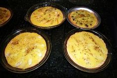 four pans filled with food sitting on top of a black countertop next to each other