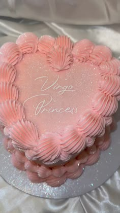 a pink heart shaped cake with the words yoga princess written on it's frosting