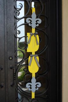 an iron door with yellow and gray decorations