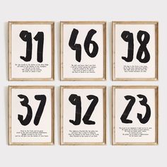 four black and white prints with numbers on them in wooden frames, each featuring the same number