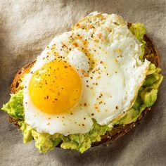 an egg and avocado toast on a piece of paper