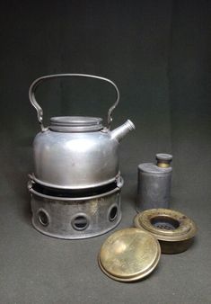 an old tea kettle and other items on a table