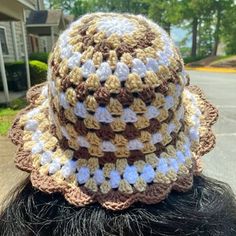 a close up of a person wearing a crocheted hat on top of their head