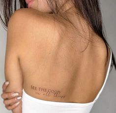 the back of a woman's shoulder with an inscription on it that says see the good