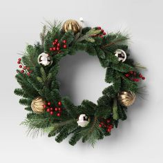 a christmas wreath with ornaments hanging from it