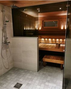 a bathroom with a wooden sauna and tiled floor