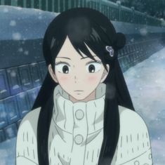 a girl with long black hair standing in the snow