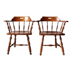 two wooden chairs sitting next to each other