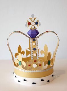 a gold and white crown sitting on top of a table