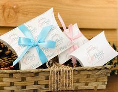 a basket filled with pine cones and wrapped in blue ribbon