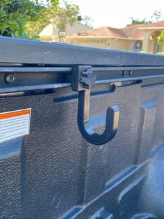 the back end of a truck with an orange tag on it's door handle