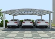 three white cars parked under a metal structure