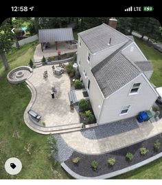 an aerial view of a house with a car parked in the driveway