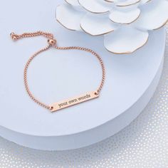 Any woman will look and feel great in this adjustable slide bracelet. We'll custom engrave it with your own words. It's a great gift for weddings, birthdays, Christmas, or Valentine's Day! CUSTOM ENGRAVING: ENGRAVING: [Your Own Words - 25 character max] BACK: [Optional, adds $10, 25 character max] DETAILS: MATERIAL: stainless steel FINISHES: gold, rose gold, stainless steel FIT: adjustable, one size fits most STYLE: slide, fits over hand BRACELET SIZE: up to 9 inches in diameter Custom Text Adjustable Jewelry, Inspirational Adjustable Jewelry With Engraving Option, Mother's Day Engraved Adjustable Name Bracelet, Adjustable Rose Gold Nameplate Jewelry, Elegant Adjustable Name Bracelet With Custom Text, Personalized Adjustable Meaningful Jewelry, Adjustable Meaningful Name Bracelet As Gift, Meaningful Personalized Adjustable Jewelry, Meaningful Adjustable Jewelry For Personalized Gift