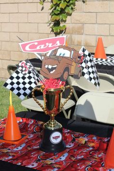 a trophy sitting on top of a table next to cones