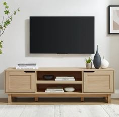 a flat screen tv mounted to the side of a wooden entertainment center in a living room