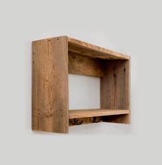 a wooden shelf mounted to the side of a wall with two shelves on each side