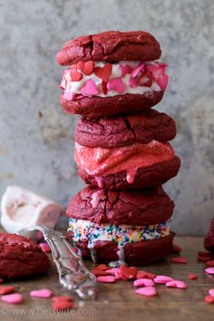 red velvet cookies stacked on top of each other with sprinkles and hearts