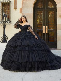 Be the center of attention in this beaded long off the shoulder puff sleeve dress with A-line tiered skirt by House of Wu 26068. Romantic quinceañera dress features a sweetheart neckline with off-the-shoulder illusion straps. A fully crystal beaded bodice is paired with a multiple tiered ruffle ball gown glitter tulle skirt. Lace-up back, royal train, and optional detachable boho tulle sleeves complete the look. The removable long sheer sleeves are included - giving you a versatile second look! Marie Sleeve, Ruffle Ball Gown, Black Quinceanera, Black Quinceanera Dresses, Quinceanera Collection, Basque Waist, Debutante Ball, Quince Dress, Tulle Sleeves