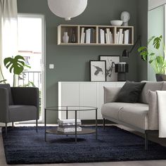 a living room filled with furniture and bookshelves