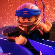 a lego character in a helmet and goggles holding a blue object with purple lights behind him