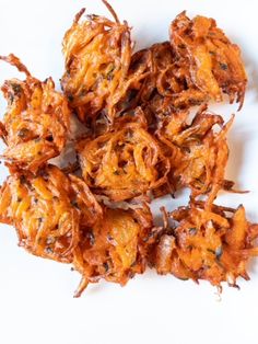 onion bhajits on a white plate with the words onion bhabj's