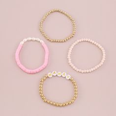 A stretch bracelet set featuring alphabet-letter beads, shimmering pearls and rainbow disc accents. Includes white and 18k gold-plated text beaded stretch bracelet, 18k gold-plated beaded stretch bracelet, blue and white beaded stretch bracelet and pearl and pink multicolor beaded stretch bracelet (four pieces total) Full graphic text (white and 18k gold-plated bracelet): Mama. Bracelet Height : 0.24" H to 0.31" H Bracelet Length : 6.5" L each 18k gold-plated copper / acrylic / polymer clay / pearl Trendy Gold Charm Bracelet With Letter Beads, Trendy Round Jewelry With Letter Beads, Trendy Gold Beads Stretch Bracelet, Trendy Gold Beads Stretch Bracelet For Everyday, Trendy Gold Beaded Stretch Bracelet For Everyday, Spring Jewelry With Colorful Beads In Gold, Spring Gold Jewelry With Colorful Beads, Adjustable Letter Beads Jewelry For Spring, Trendy Letter Beads Jewelry For Friendship