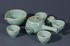 a group of teapots and cups sitting next to each other