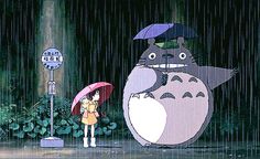 a person holding an umbrella standing in the rain with a totoro behind them