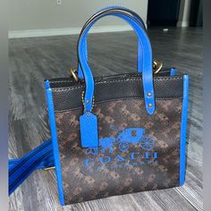 Great Condition, Never Used Blue Top Handle Bag With Leather Handles, Designer Blue Satchel With Leather Handles, Designer Blue Tote Satchel, Designer Blue Satchel Tote, Designer Blue Tote Bag, Designer Blue Bags With Leather Handles, Brown Medium Shoulder Bag With Dust Bag Included, Medium Brown Shoulder Bag With Dust Bag Included, Blue Coated Canvas Bag With Handles