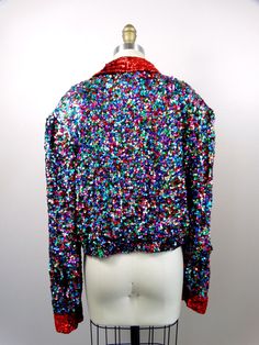 "This is such a colorful vintage piece! It's completely hand embellished with bright and colorful sequins and is in excellent condition! Measurements are taken with the front brought together and both bottom closures intact. Bust - 48\" Waist - 40\" (taken around bottom hem) Length - 19\" Tag Size - Extra Large All of my items come from a smoke-free and pet-free home. If you have any questions, please don't hesitate to ask!" Party Multicolor Sequined Outerwear, Multicolor Sequined Party Outerwear, Multicolor Sequined Outerwear For Party Season, Fitted Multicolor Sequined Outerwear, Multicolor Embellished Party Outerwear, Embellished Multicolor Party Outerwear, Festive Multicolor Embellished Outerwear, Checkered Jacket, Sequin Jacket