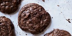 four chocolate cookies sitting on top of a table